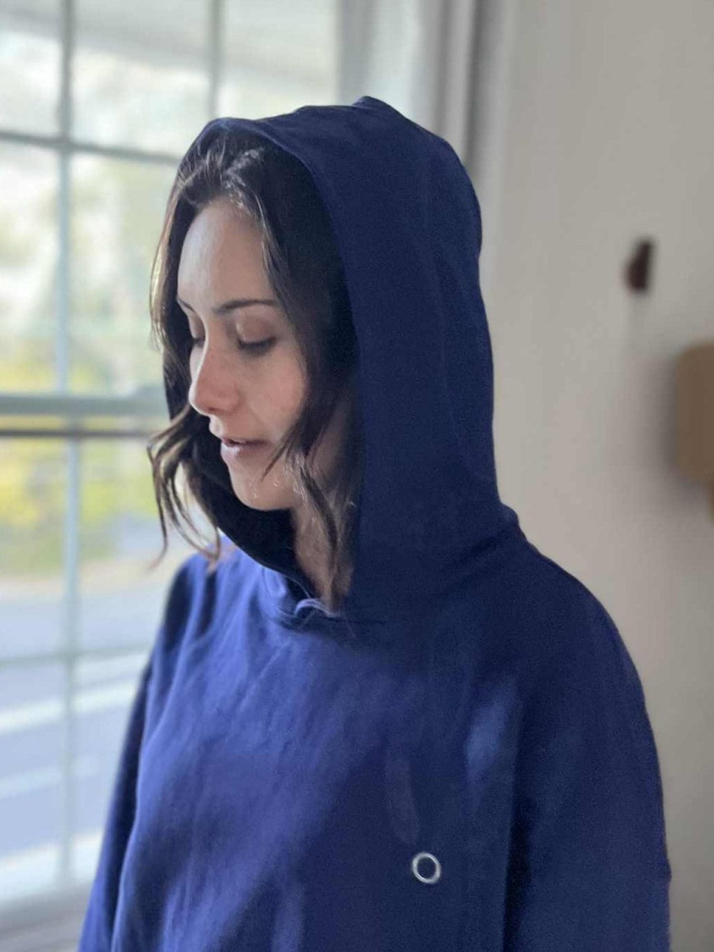 SpaceHood Zero hoodie in navy, hood up over headphones